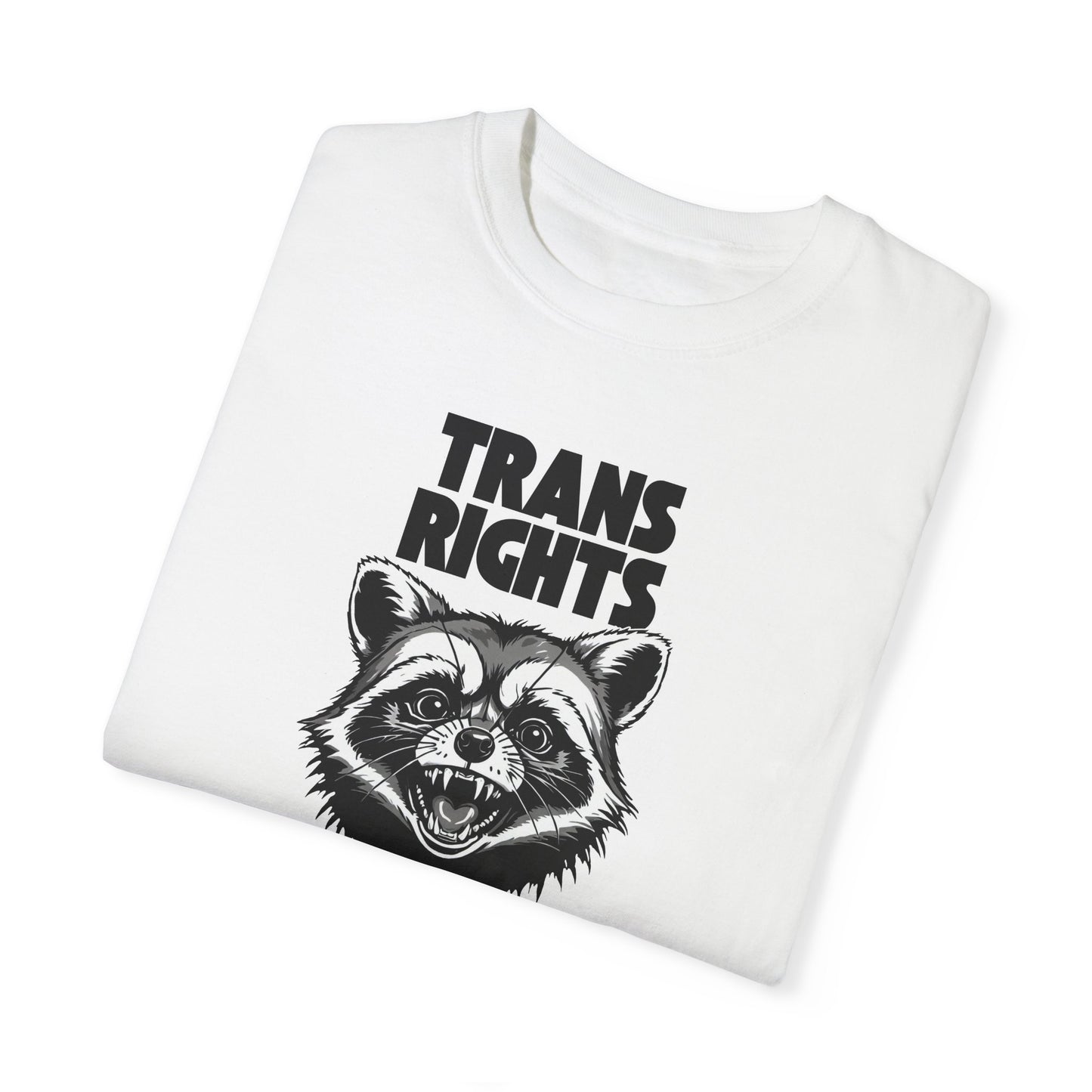 Flat lay of a white tee featuring a fierce raccoon and bold text 'TRANS RIGHTS' for supporters of LGBTQ+ rights. 🦝